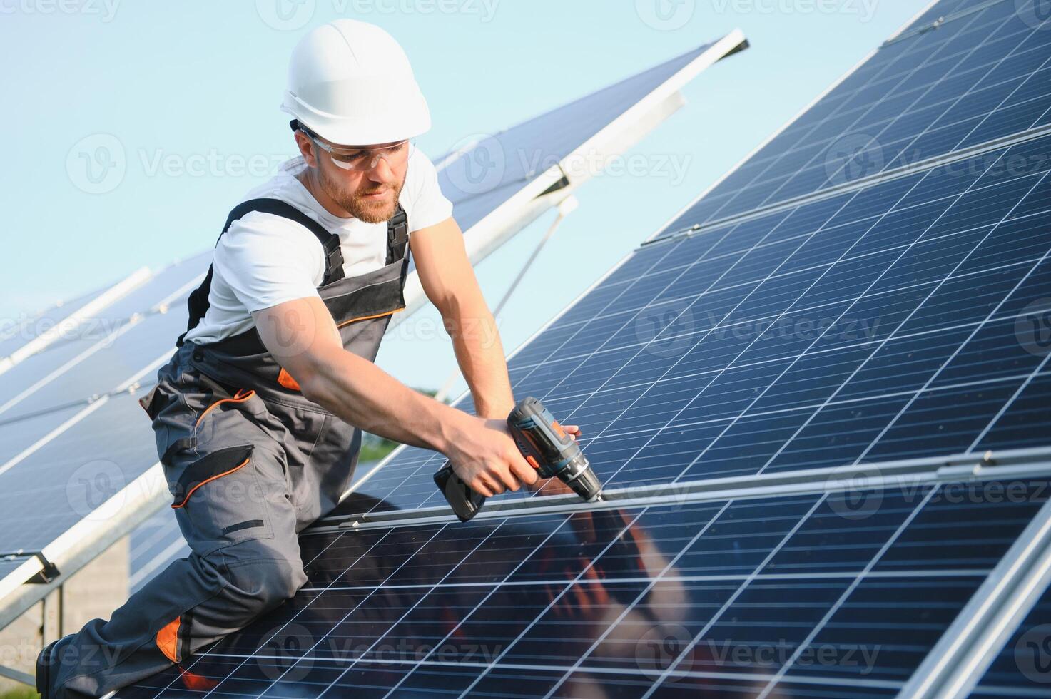 Worker installing solar panels outdoors. photo