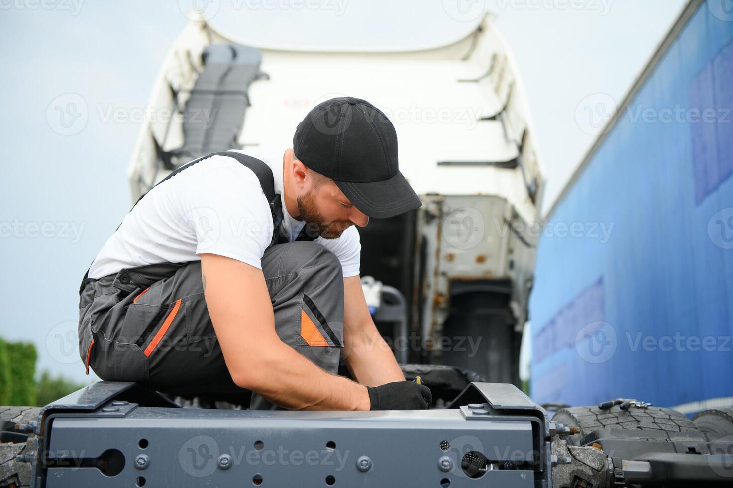 Mechanic repairing the truck in service. photo