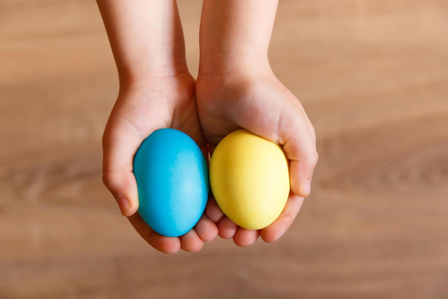 Paint eggs for Easter, bright Easter holiday, children paint eggs, colored eggs in a basket, colored eggs on a stand, Holiday background photo
