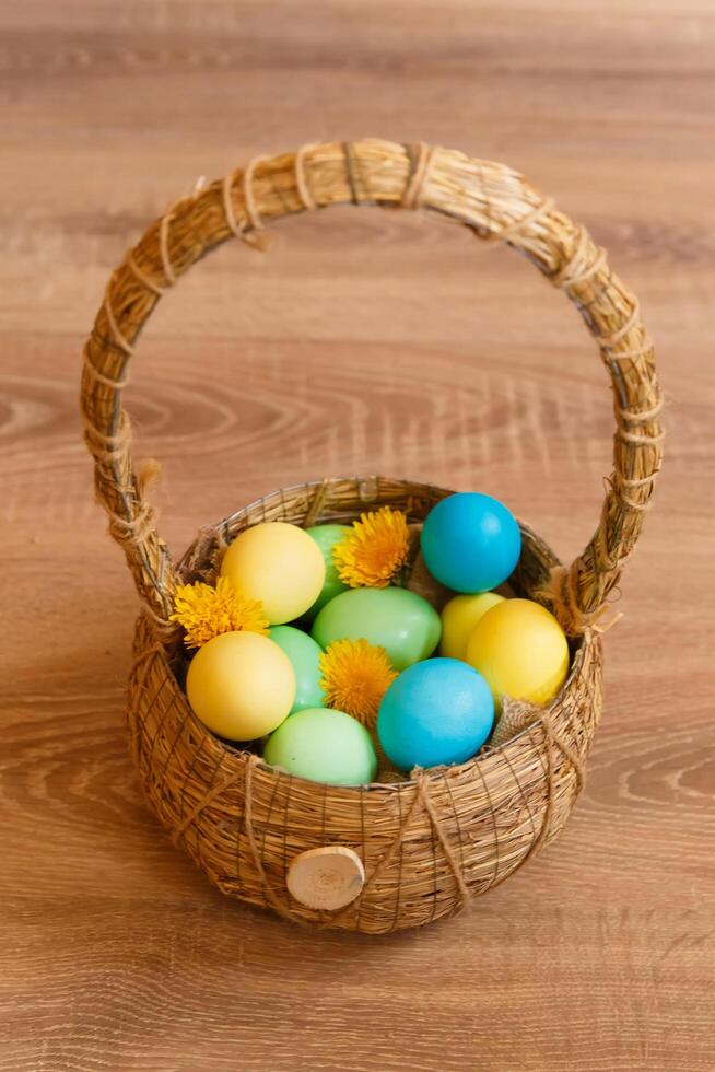Paint eggs for Easter, bright Easter holiday, children paint eggs, colored eggs in a basket, colored eggs on a stand, Holiday background photo