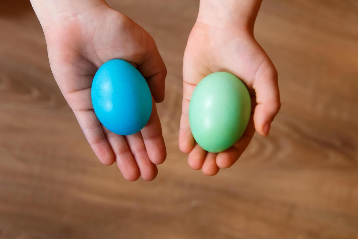 Paint eggs for Easter, bright Easter holiday, children paint eggs, colored eggs in a basket, colored eggs on a stand, Holiday background photo