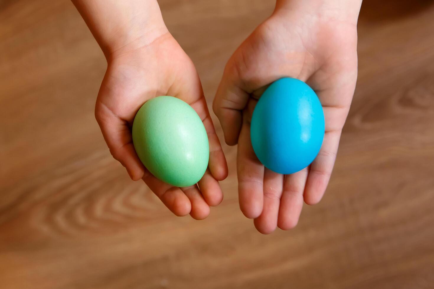 Paint eggs for Easter, bright Easter holiday, children paint eggs, colored eggs in a basket, colored eggs on a stand, Holiday background photo