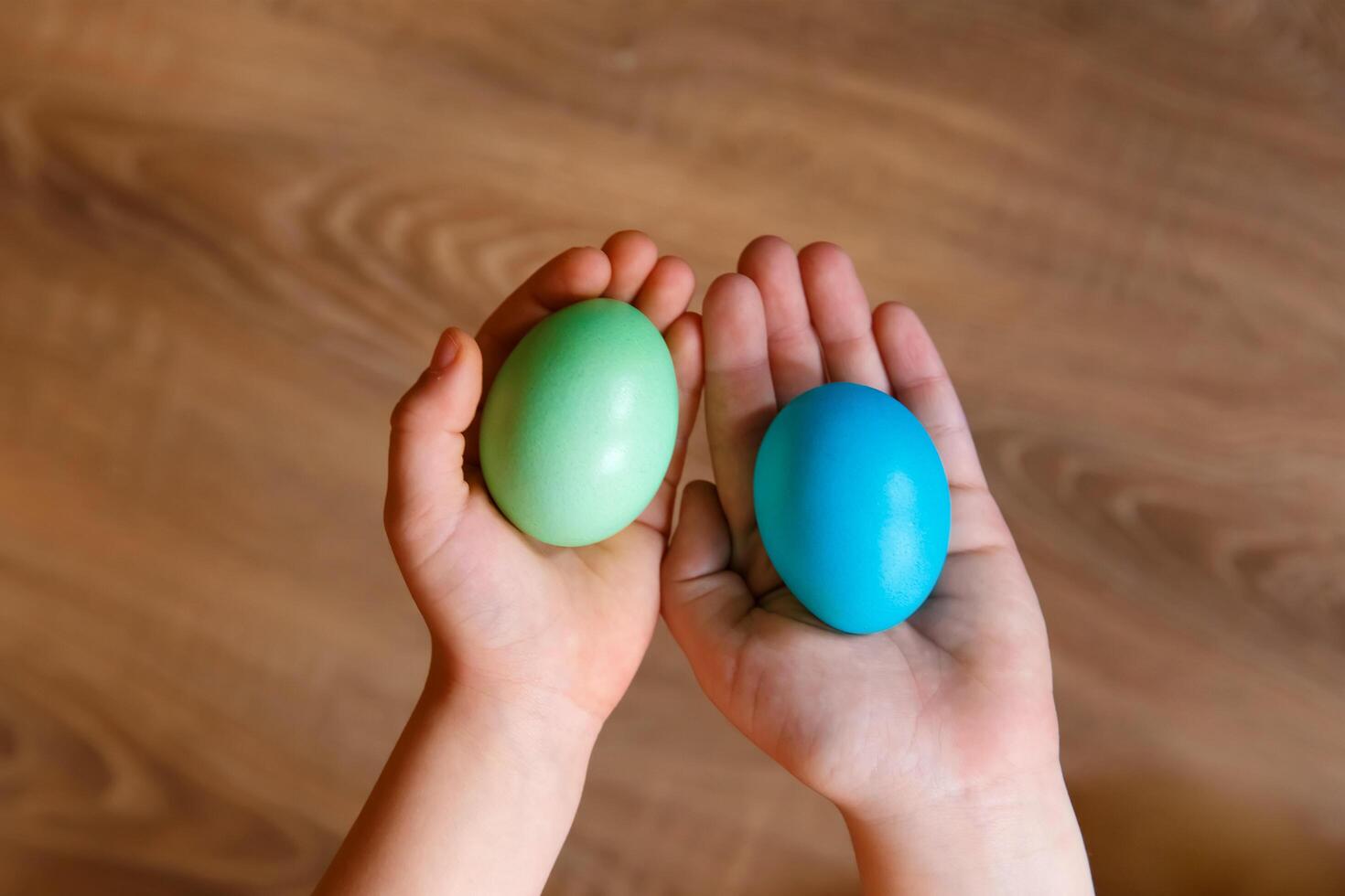 Paint eggs for Easter, bright Easter holiday, children paint eggs, colored eggs in a basket, colored eggs on a stand, Holiday background photo
