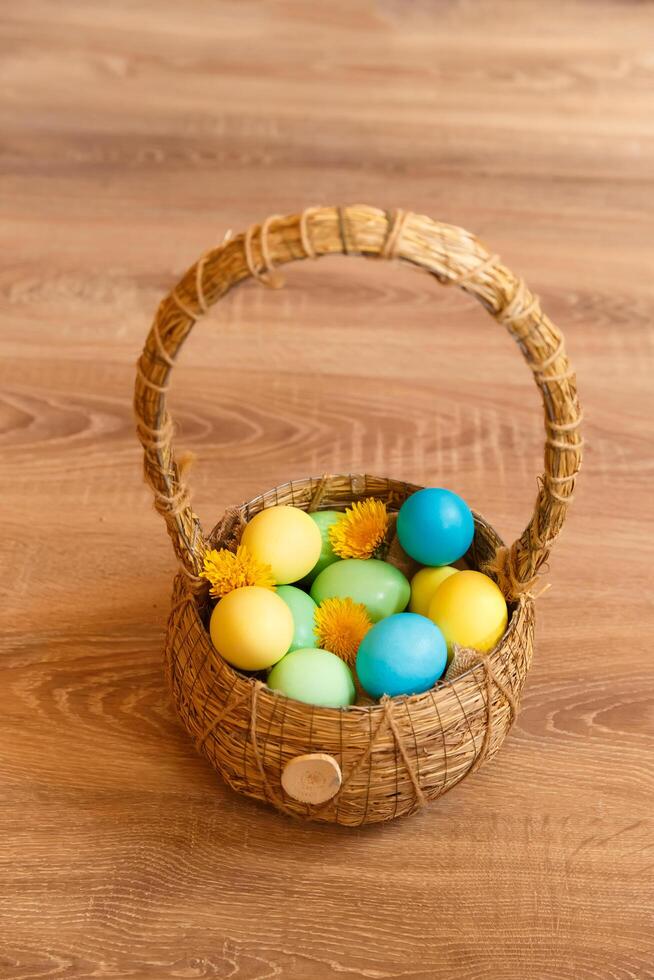 Paint eggs for Easter, bright Easter holiday, children paint eggs, colored eggs in a basket, colored eggs on a stand, Holiday background photo