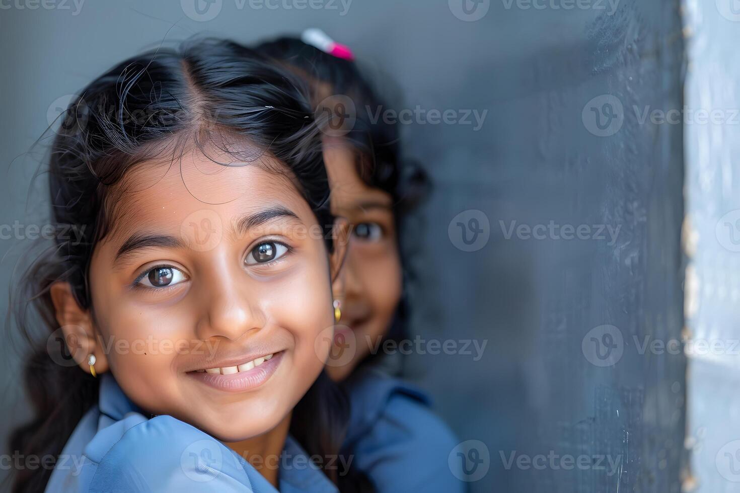 ai generado dos pequeño muchachas sonriente y mirando a el cámara con un azul pared foto