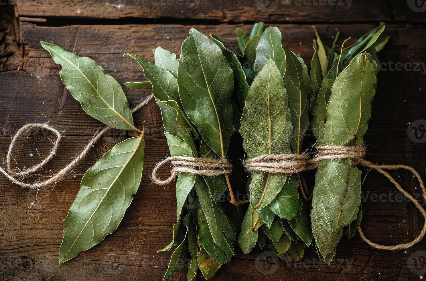 AI generated Bay leaves tied with string on rustic wooden background photo