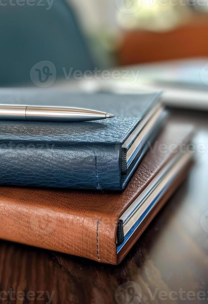 ai generado Tres cuero cuadernos y bolígrafo en de madera mesa foto