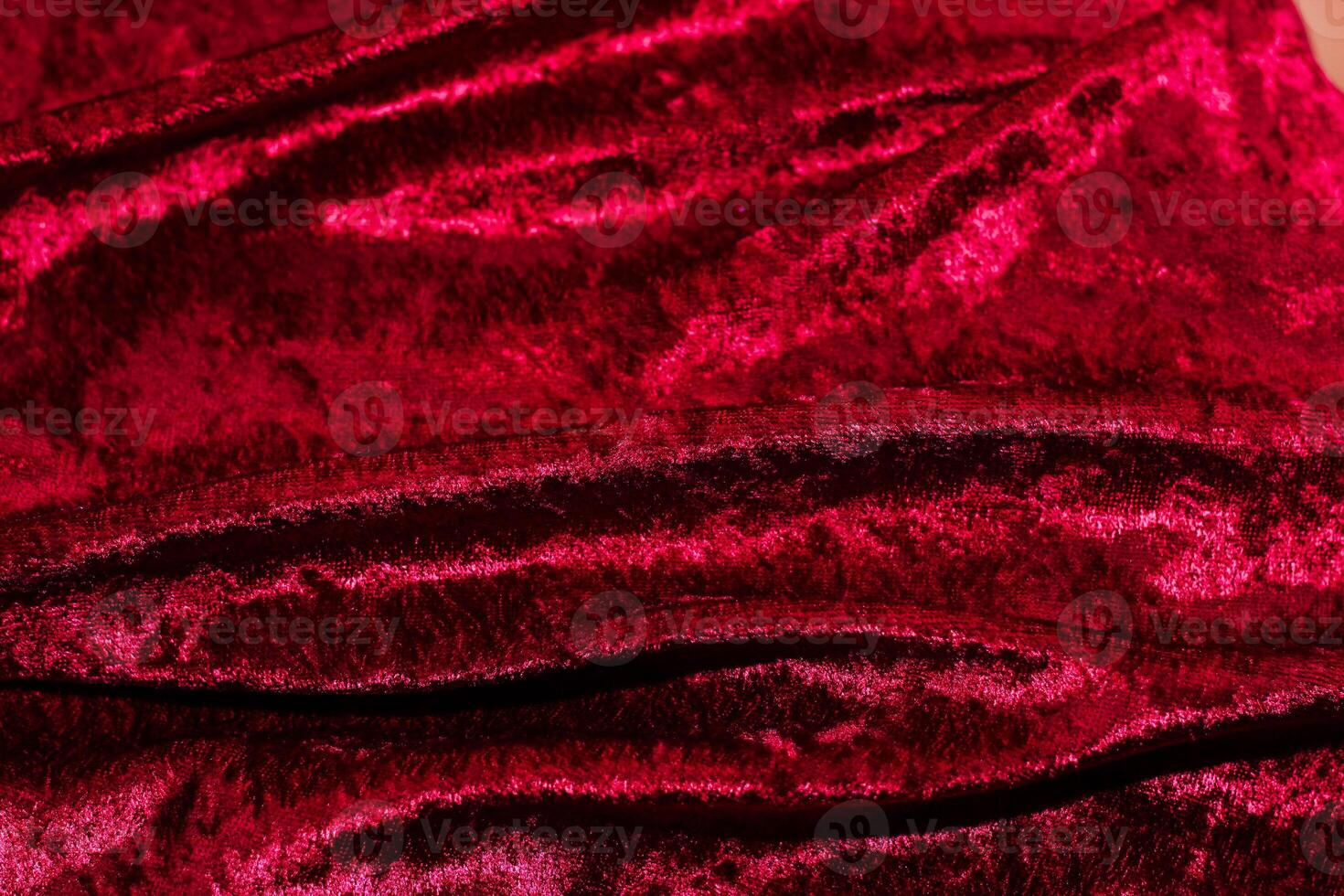 Texture of red velor corduroy fabric with folds photo