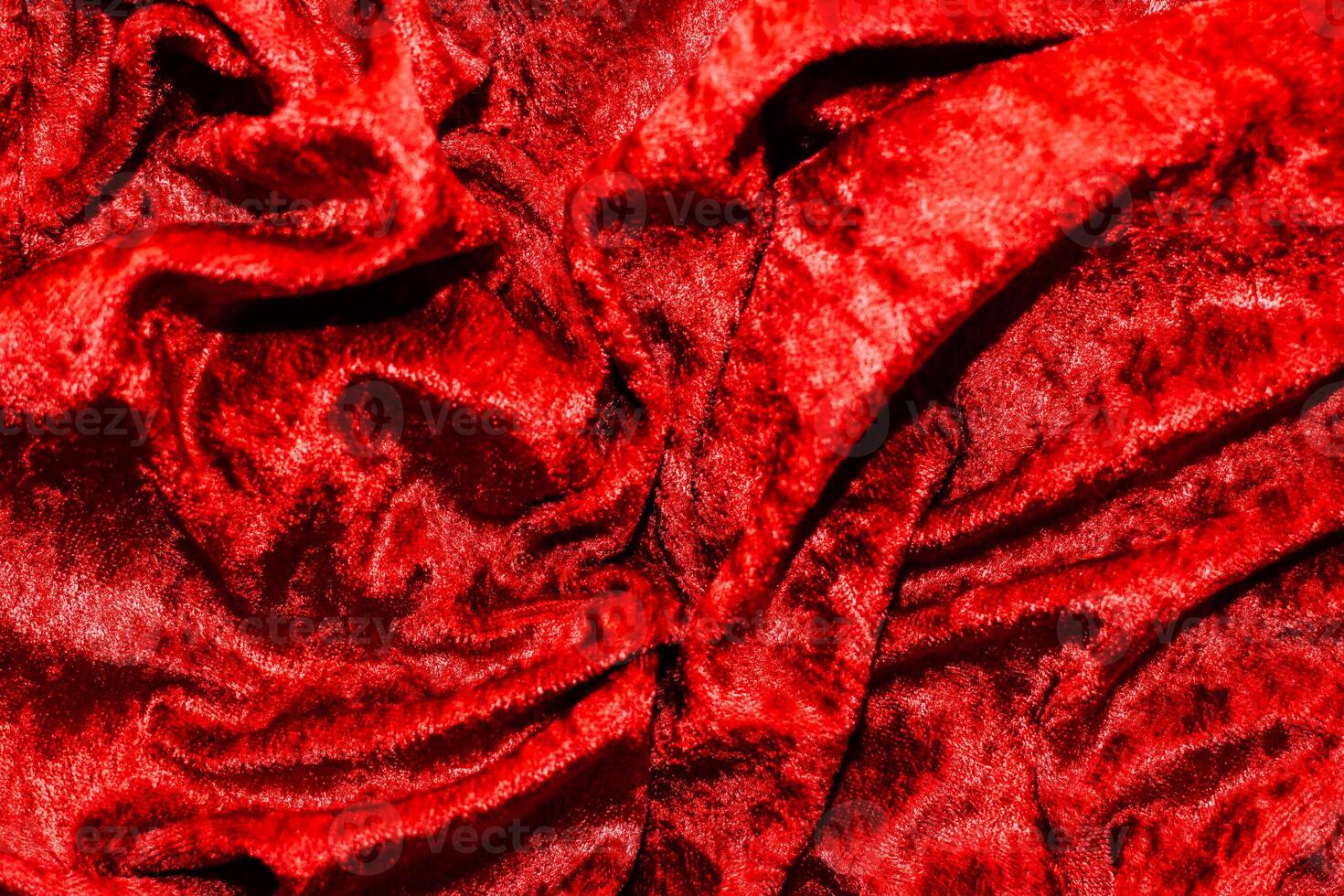 Texture of red velor corduroy fabric with folds photo