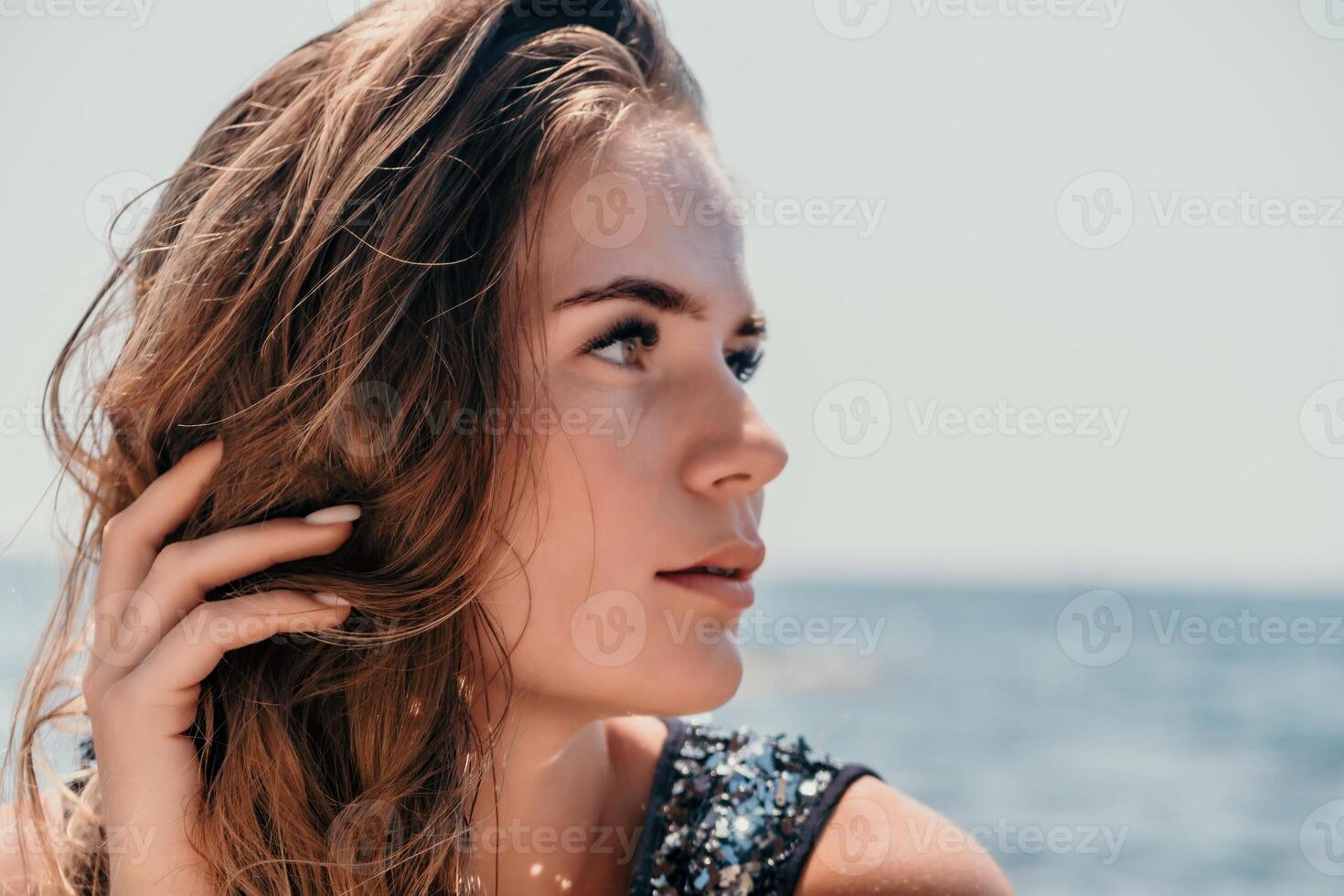 Woman summer travel sea. Happy tourist enjoy taking picture outdoors for memories. Woman traveler posing on the beach at sea surrounded by volcanic mountains, sharing travel adventure journey photo