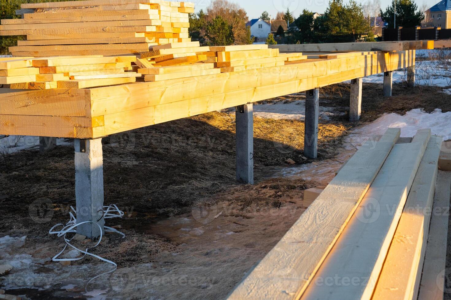The foundation of a wooden frame house on stilts is a construction site, the process of building a frame photo