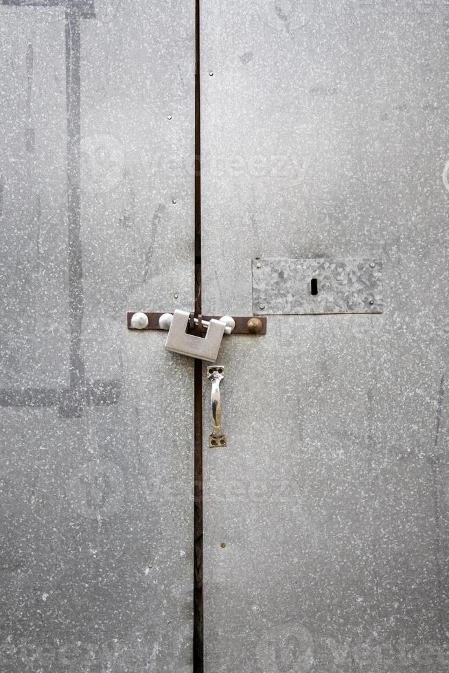 Metal door with padlock photo