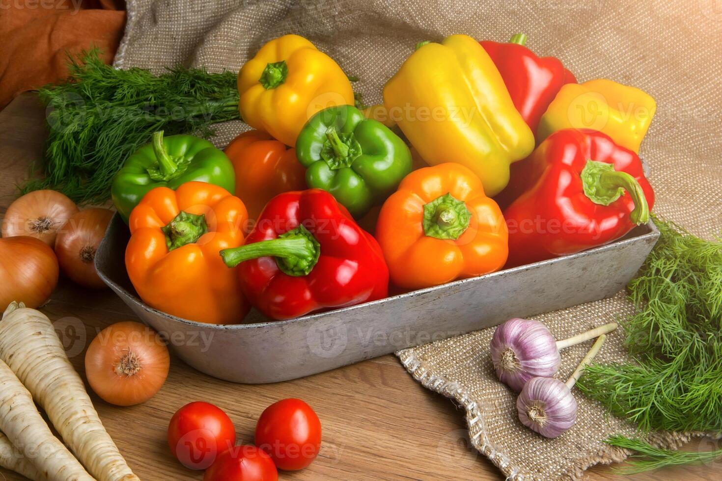 Red, green and yellow sweet bell peppers on table, photo