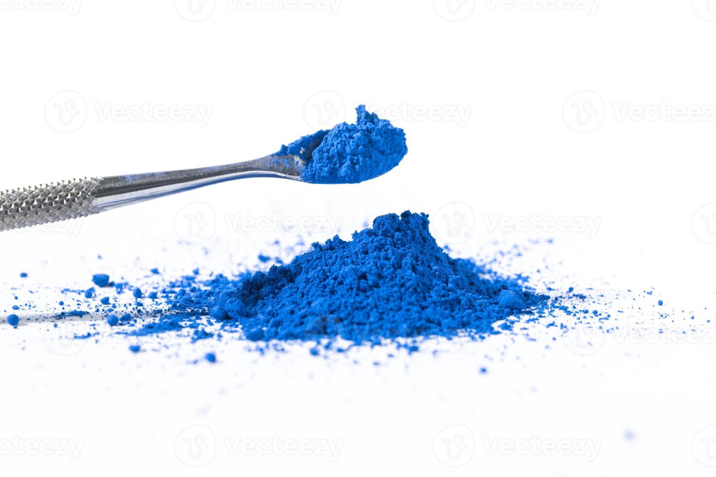 ultramarine pigment, dry paint on a white background, macro photo