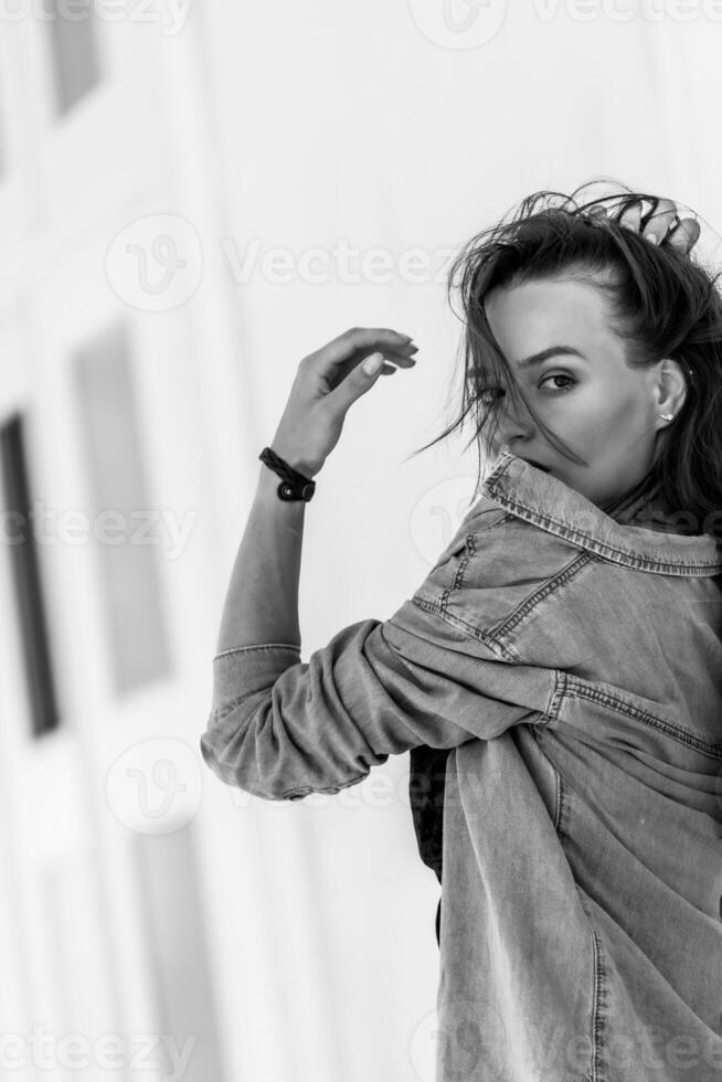 Emotional portrait of pretty woman. Photo in a move. Flying hair and beautiful smile. Black and white photo.