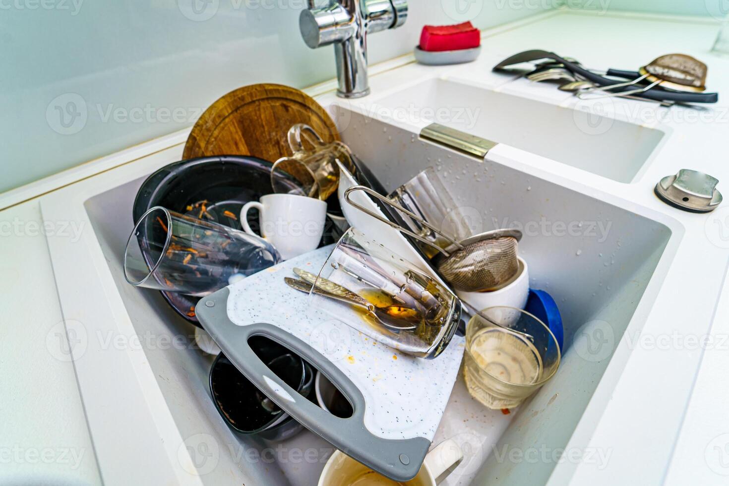 Kitchen conceptual image. Dirty sink with many dirty dishes. photo