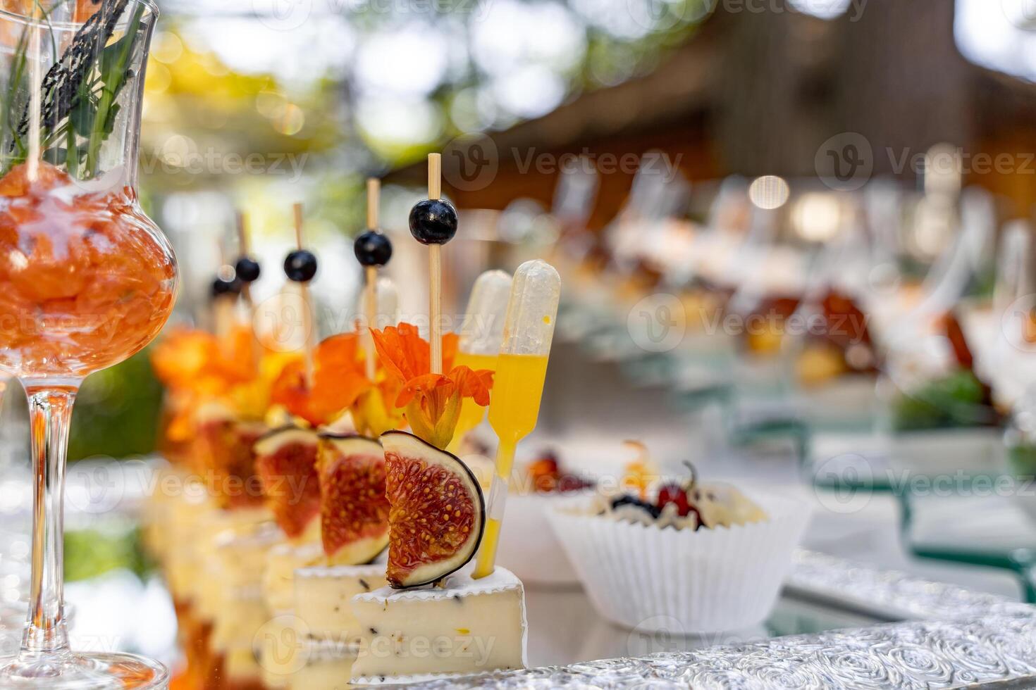 Banquet event. Table with glasses, snacks and appetizers. Celebrating event. Blurred background. photo
