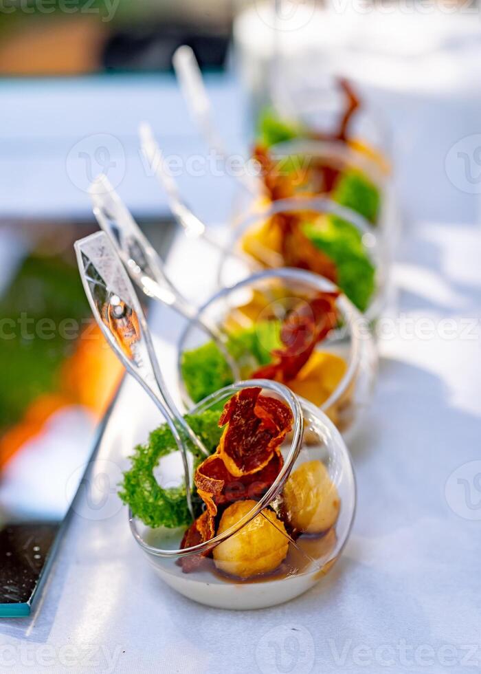Buffet table with cold appetizers and aperitifs. Modern design of ball plates. Selective focus. Close up. photo