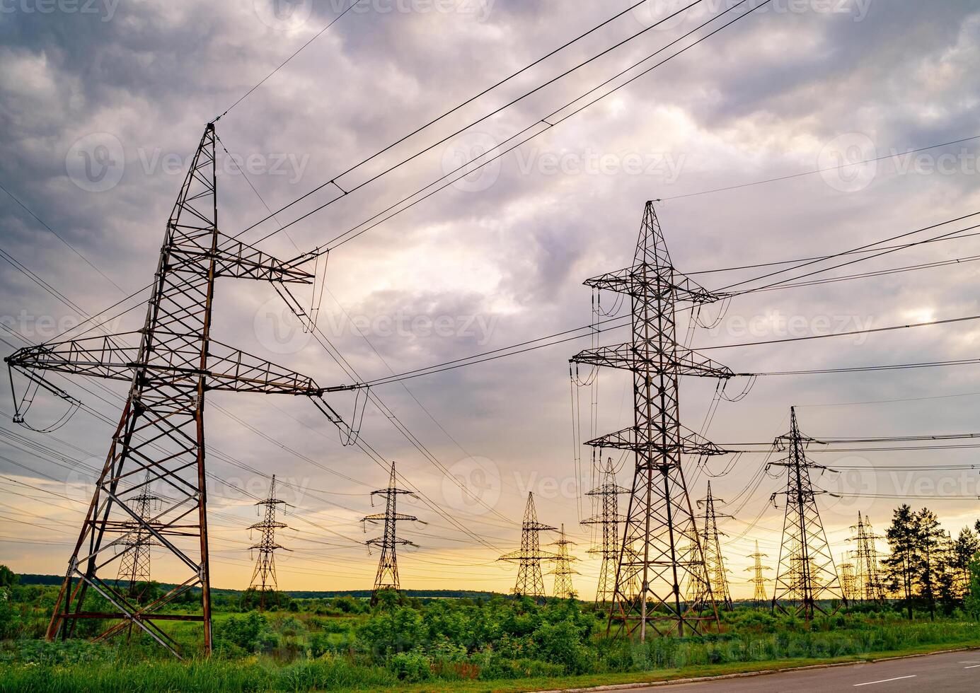 High voltage post. High voltage pylons against sunset background. Energy and industrialisation concept. Selective focus photo