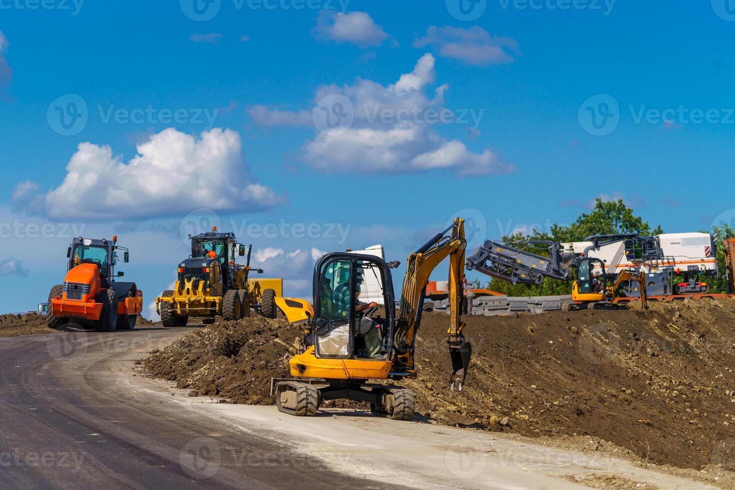 Panorama of working machinery at road. Building new road. Different types of working road equipment. photo