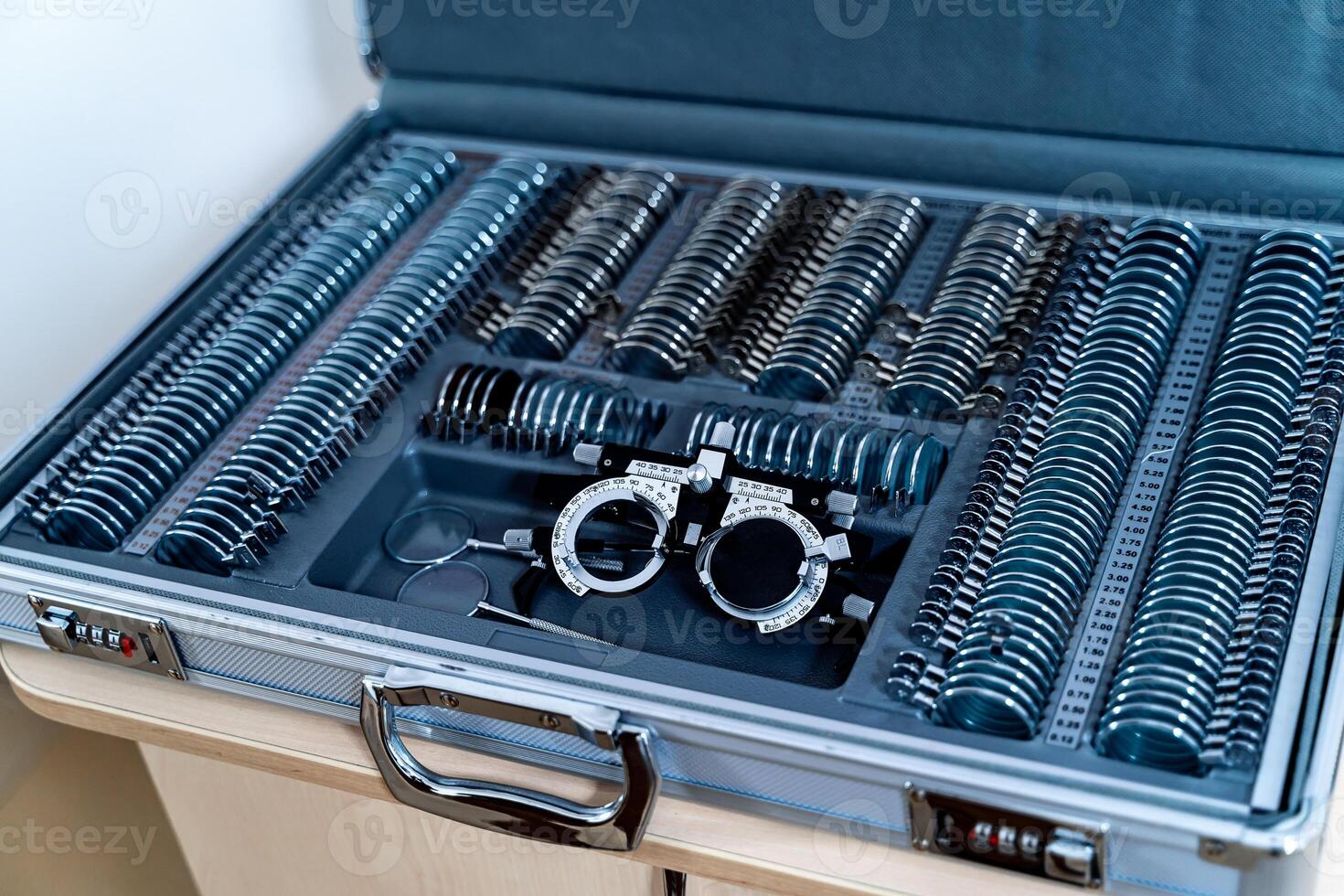 A trial frame with set of corrective lenses. Test vision equipment. Ophthalmology tool box. photo
