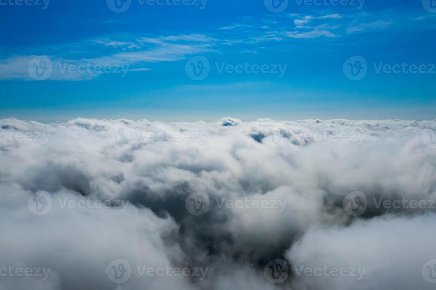 Cotton clouds below and sapphire sky above. Fluffy endless clouds. photo
