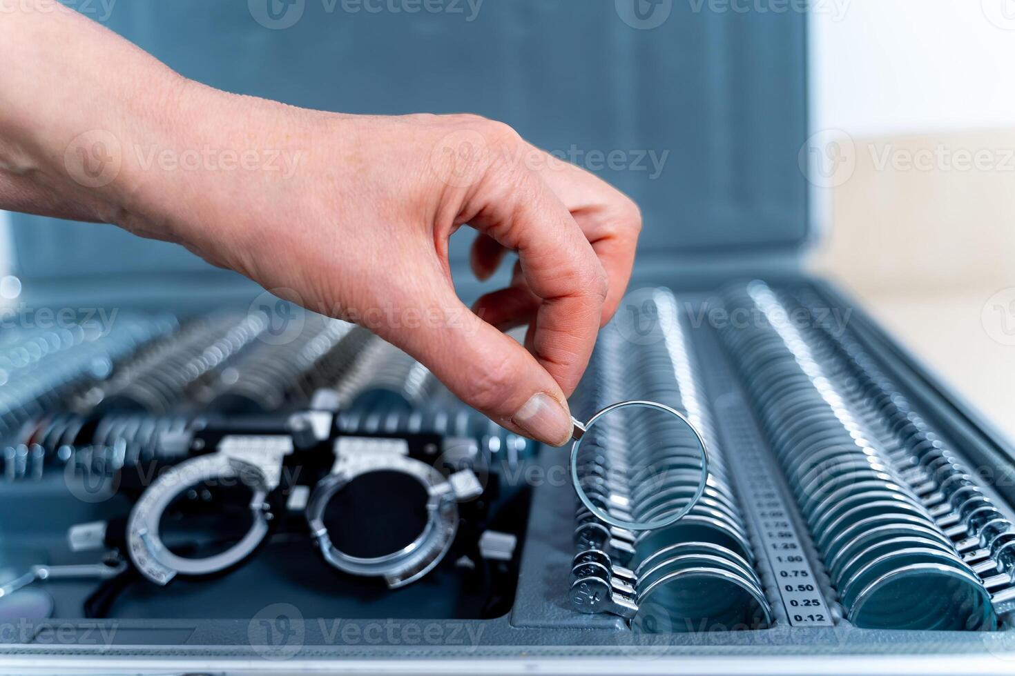 Set of corrective lenses. Eye test glasses set. Ophthalmology concept. Hand holding lenses. photo