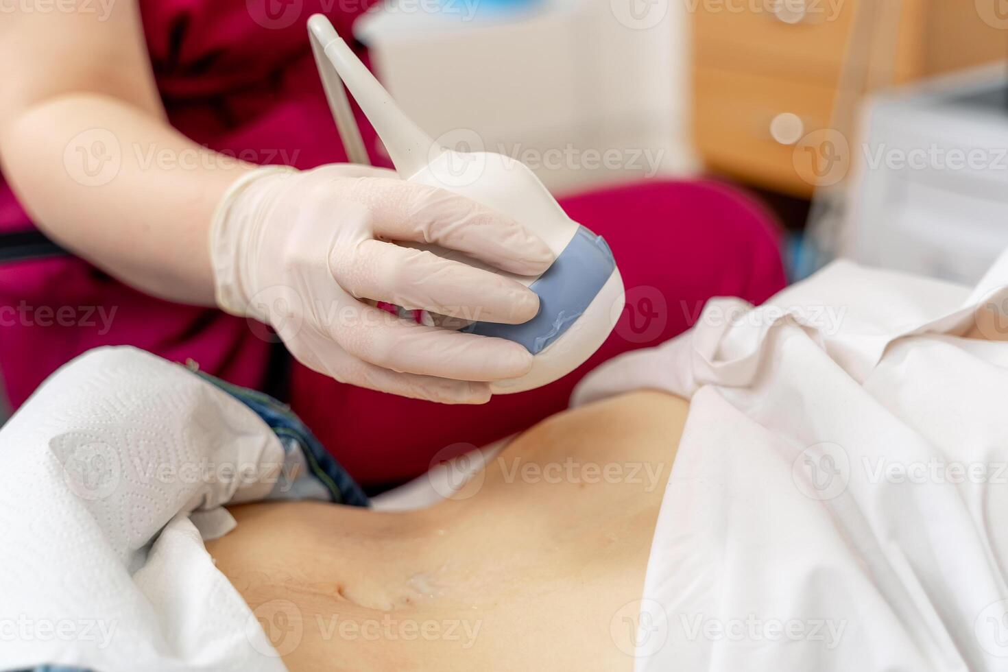 Qualified professional doctor using ultrasound equipment in clinic. Selective focus. photo