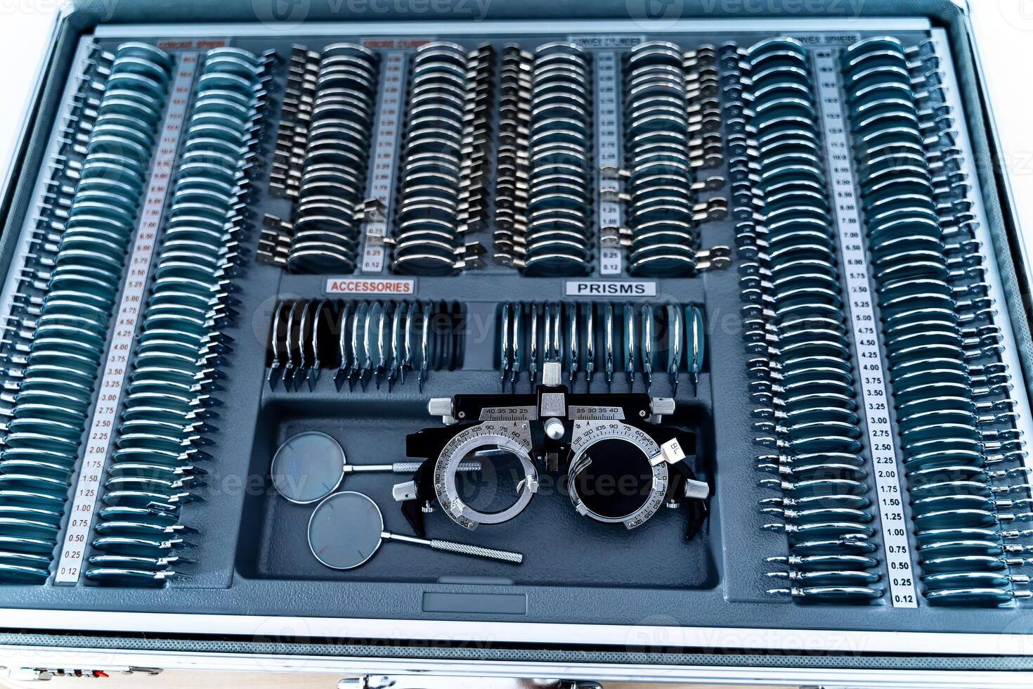 A trial frame lay down on plate with choose lenses from set of corrective lens. Test vision equipment. photo