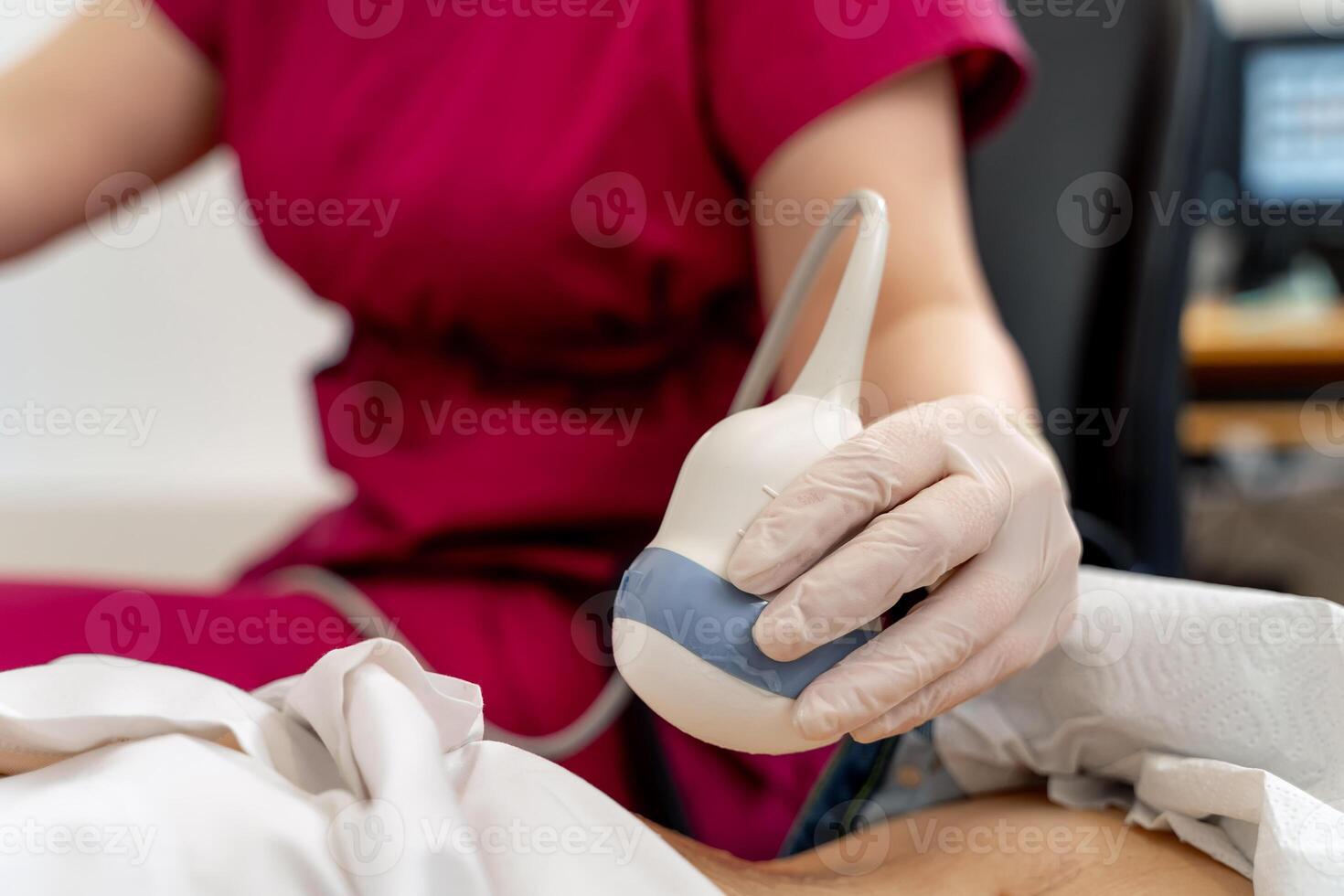 Skillful sonographer using ultrasound machine at work. Selective focus on hand. Modern clinic. photo