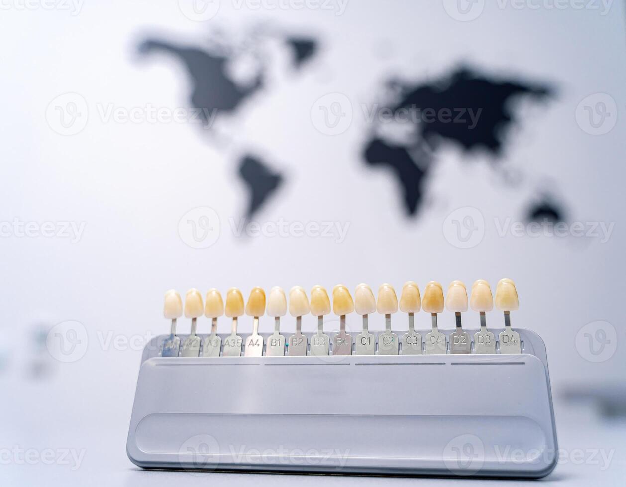 Color tone palette on front view. World map on the blurred background. Light grey background. photo