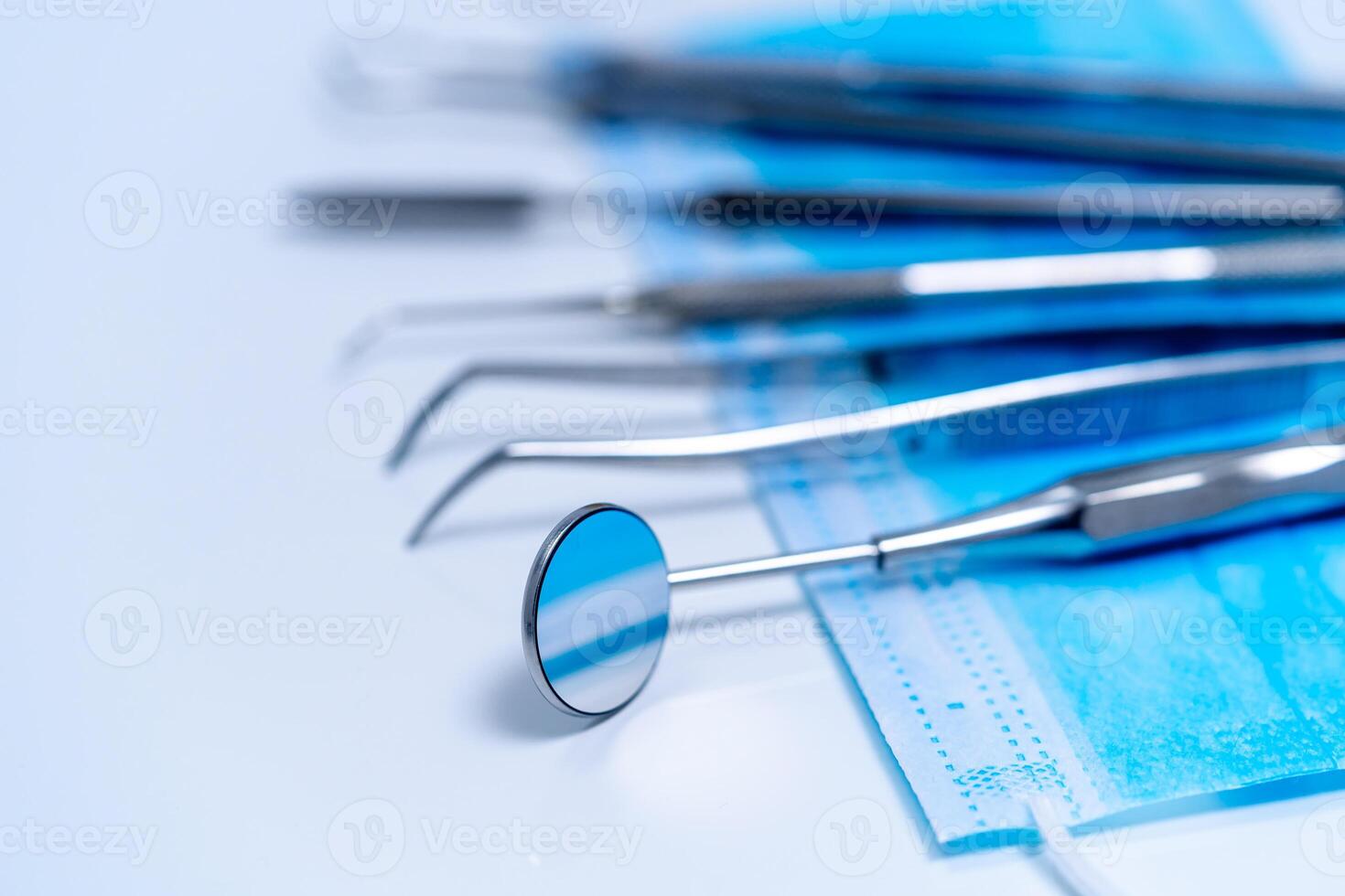 Dental treatment concept. Metal stomatology instruments. Closeup. photo