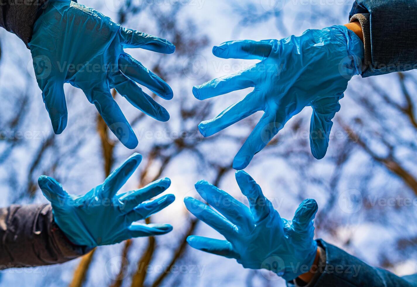 Hands in rubber medical gloves. Family at quarrantine concept. The concept of a pandemic, quarantine, prevention of viruses, diseases. Photo from below.