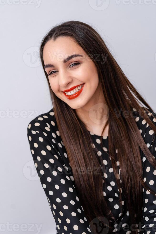 Woman smiling with perfect smile and white teeth at camera. White background. photo