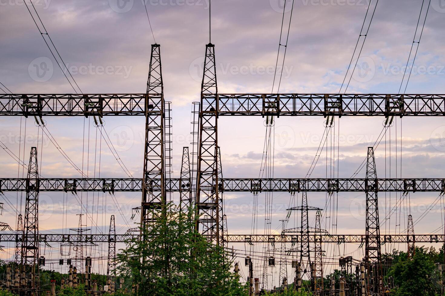High voltage post. High voltage pylons against sunset background. Energy and industrialisation concept. Selective focus photo