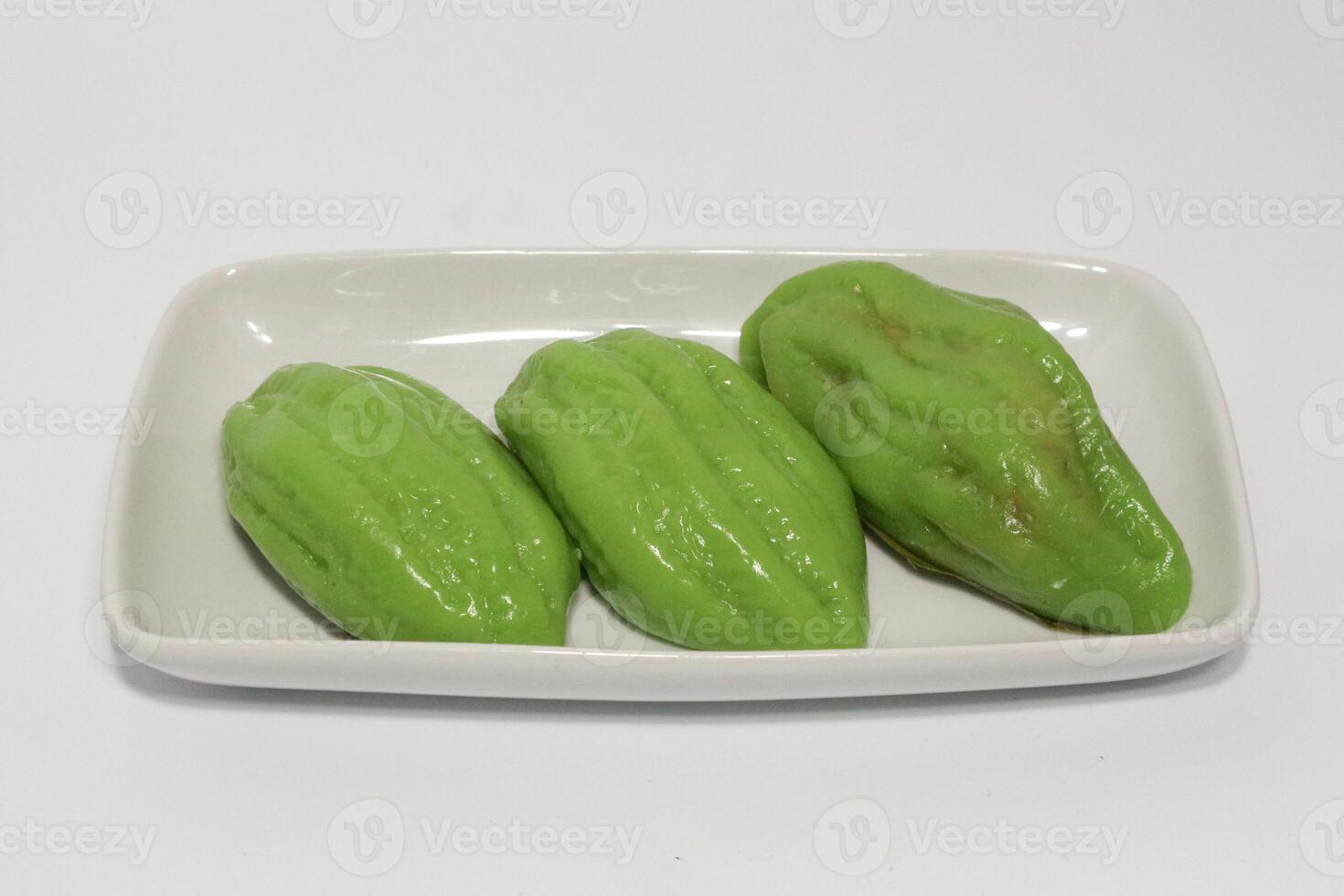 Kue Bugis, Indonesian jajan pasar, traditional snack of glutinous rice flour cake filled with sweet grated coconut, underlined with banana leaf. Popular snack during Ramadan as Takjil photo