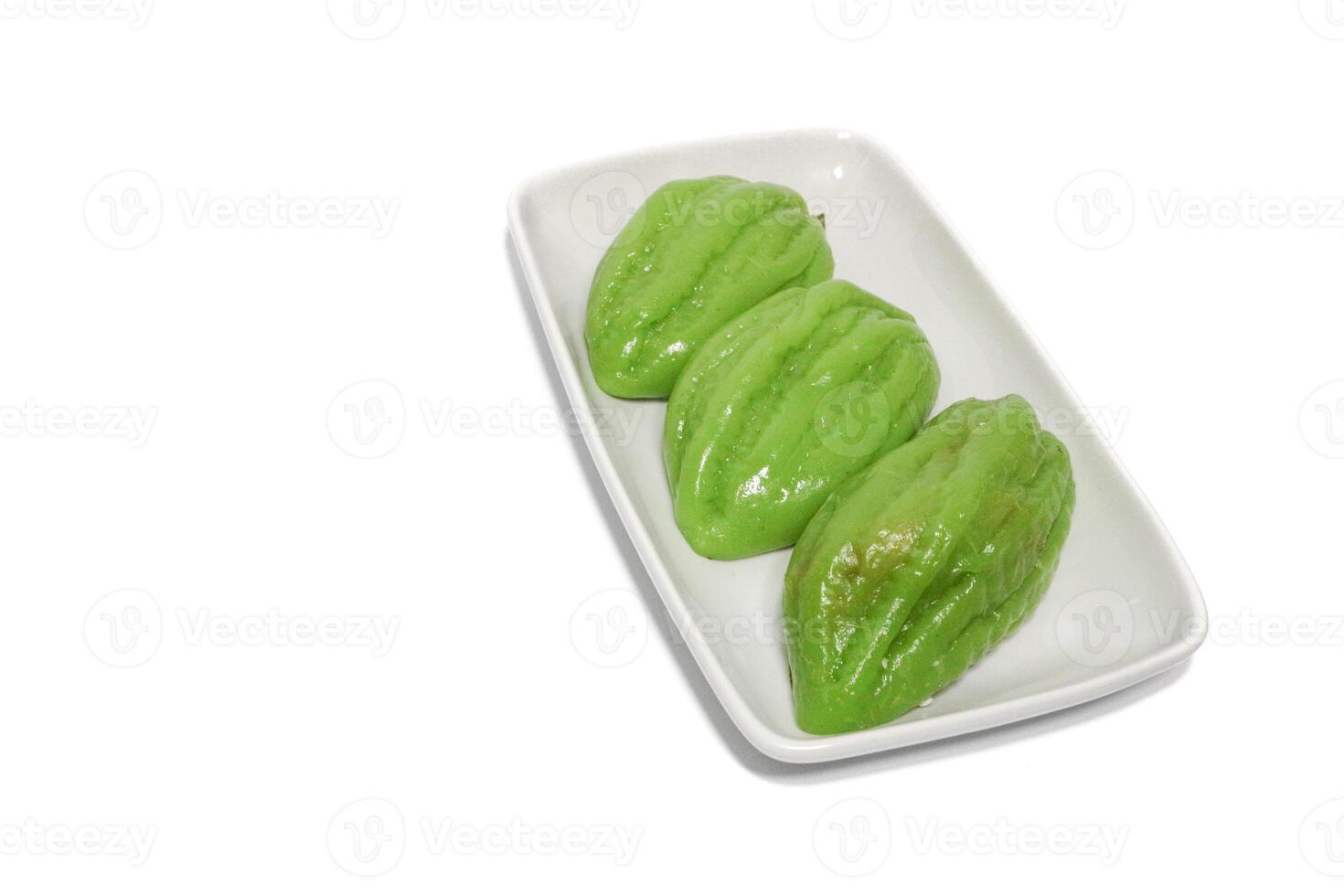 Kue Bugis, Indonesian jajan pasar, traditional snack of glutinous rice flour cake filled with sweet grated coconut, underlined with banana leaf. Popular snack during Ramadan as Takjil photo