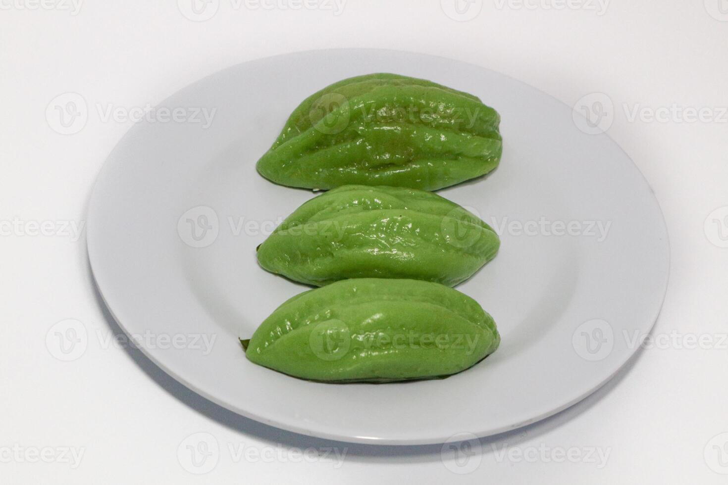 Kue Bugis, Indonesian jajan pasar, traditional snack of glutinous rice flour cake filled with sweet grated coconut, underlined with banana leaf. Popular snack during Ramadan as Takjil photo