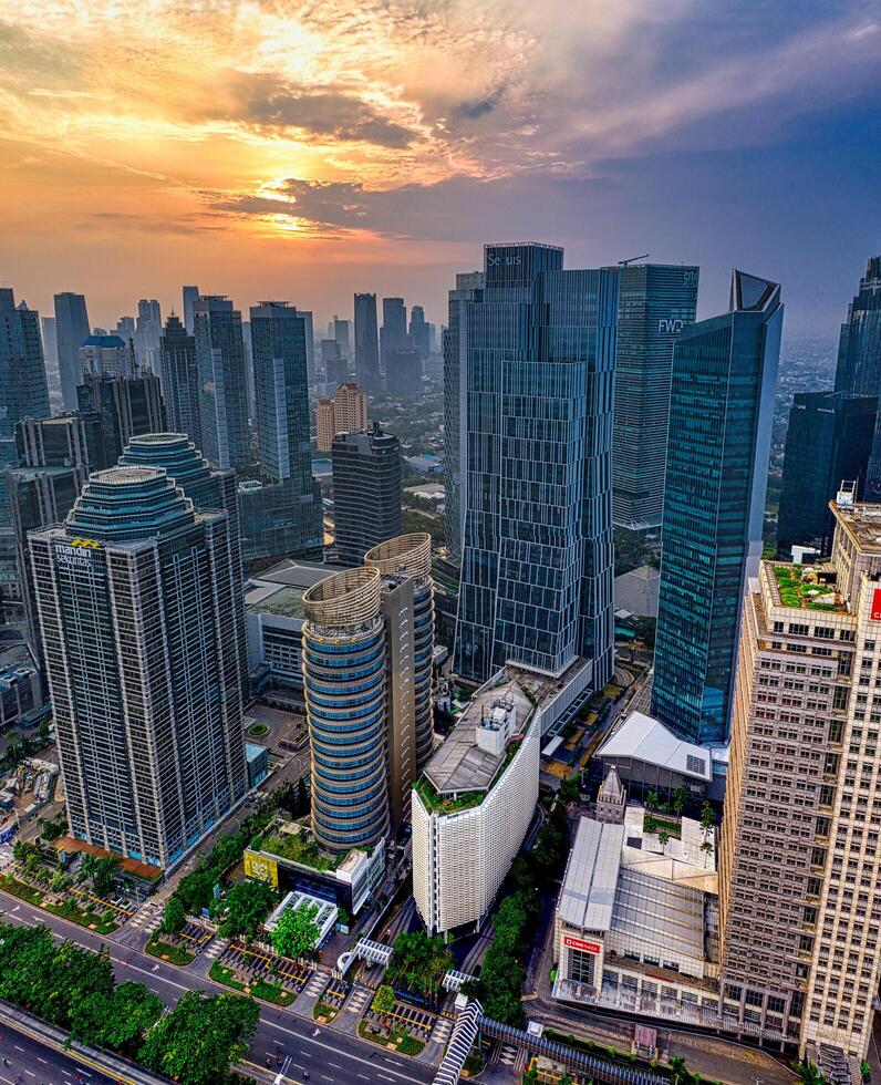 a city skyline with tall buildings and a sunset photo