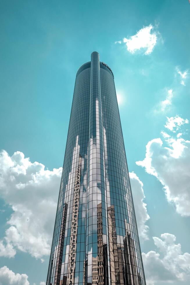 a tall building with a blue sky and clouds photo
