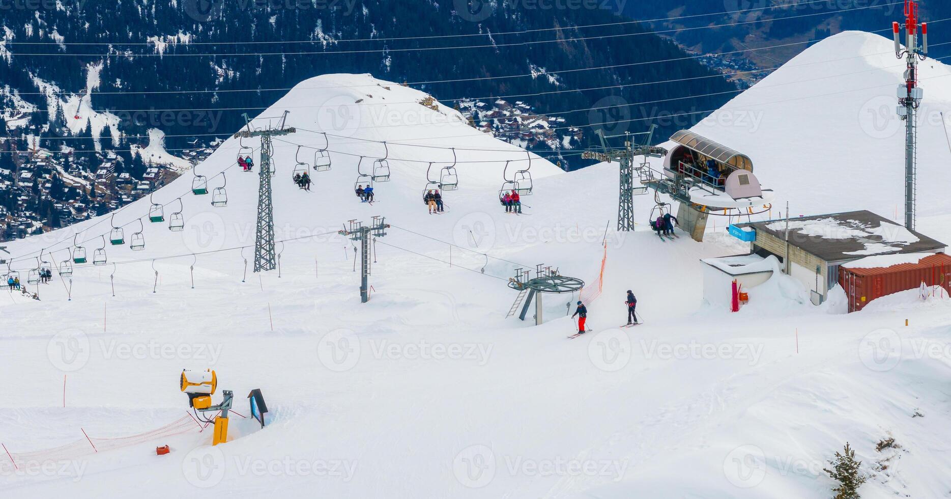 Aerial View of Busy Verbier Ski Resort, Switzerland with Snowy Slopes and Lifts photo