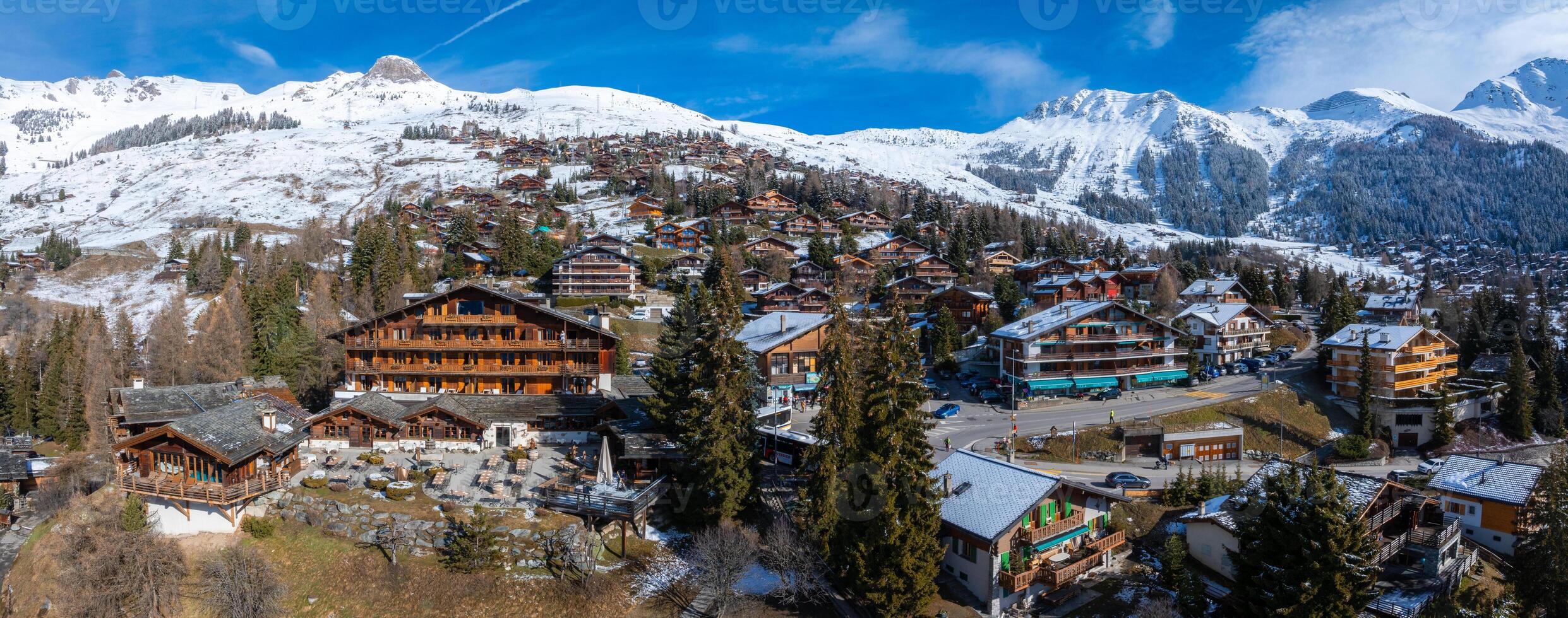 Aerial View of Verbier, Switzerland  A Luxurious Ski Town Amid Snow and Greenery photo