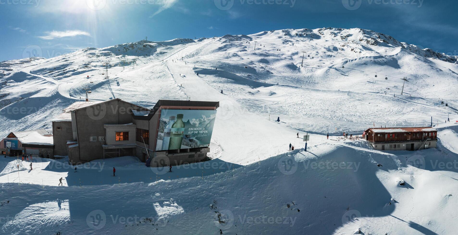 Sunny Day at Zermatt Ski Resort, Swiss Alps with Snowy Slopes and Red Train photo