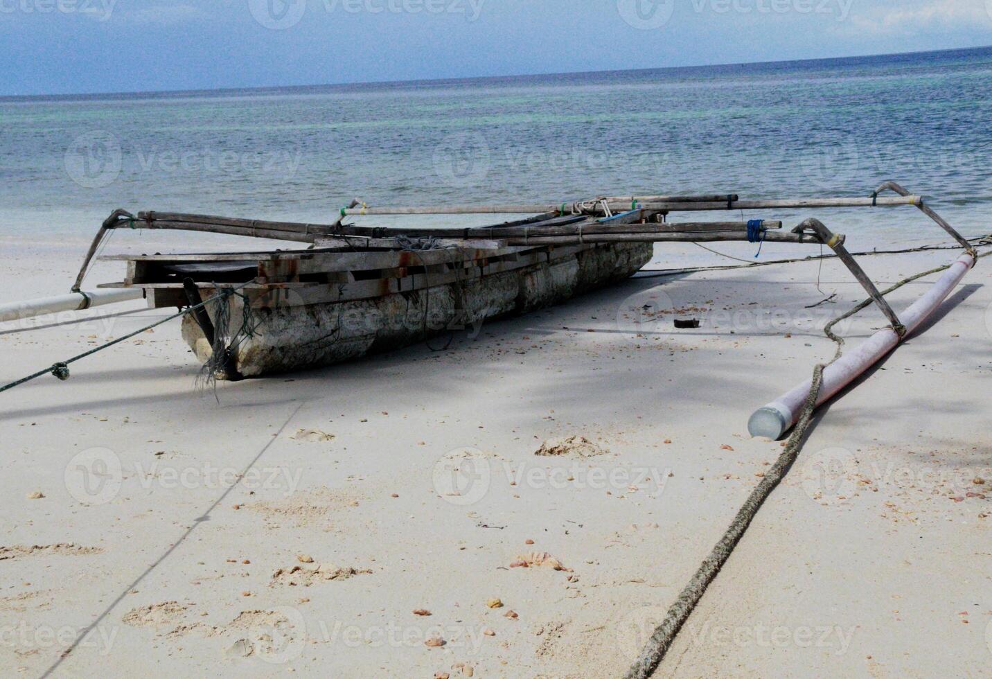 small boat on the beach, on white sand photo