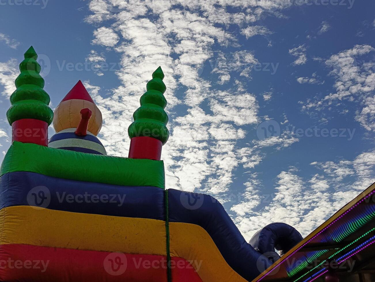 Inflatable plastic slide, low angle photo, sky background photo