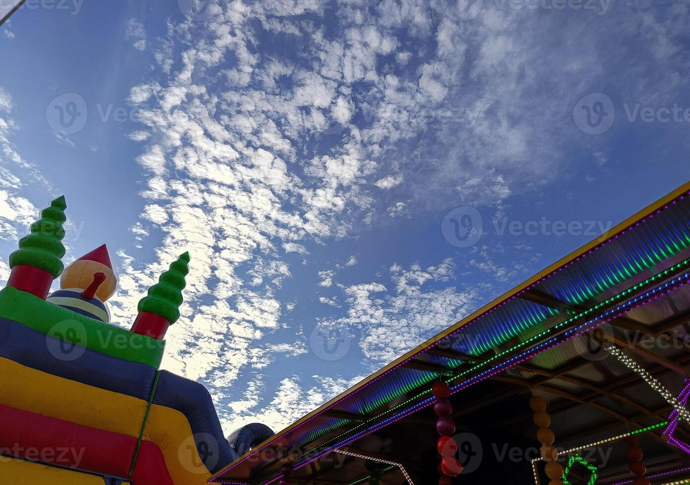 Inflatable plastic slide, low angle photo, sky background photo