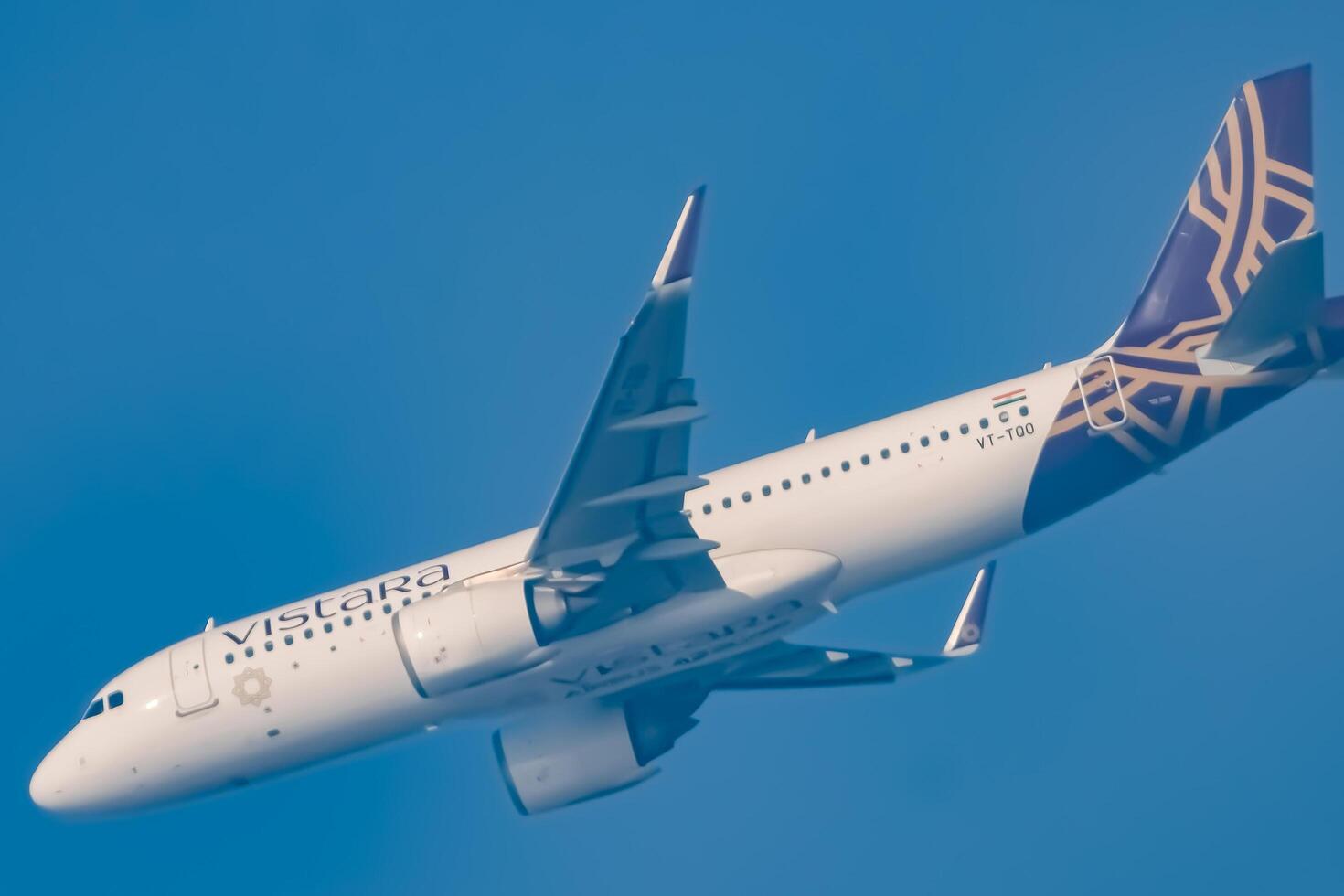 New Delhi, India, December 25 2023 - Vistara Airbus A320 neo take off from Indra Gandhi International Airport Delhi, Vistara domestic aeroplane flying in the blue sky during day time photo