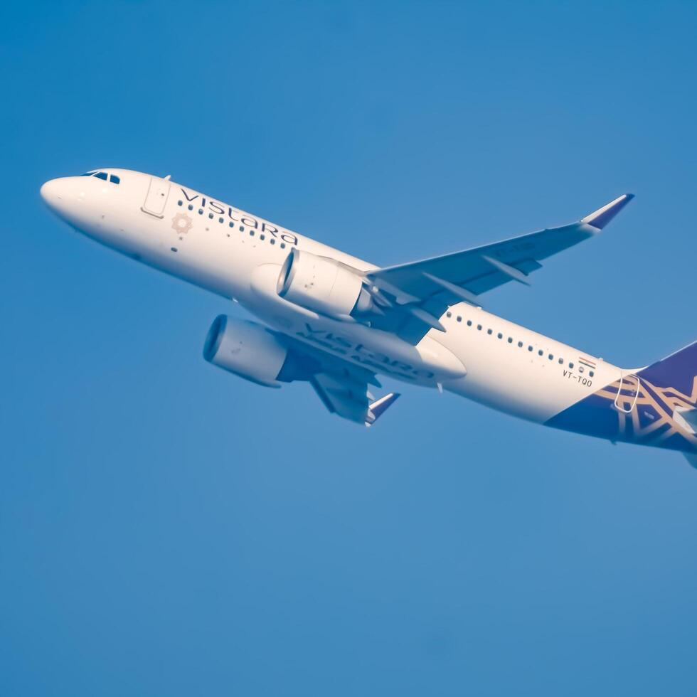 New Delhi, India, December 25 2023 - Vistara Airbus A320 neo take off from Indra Gandhi International Airport Delhi, Vistara domestic aeroplane flying in the blue sky during day time photo