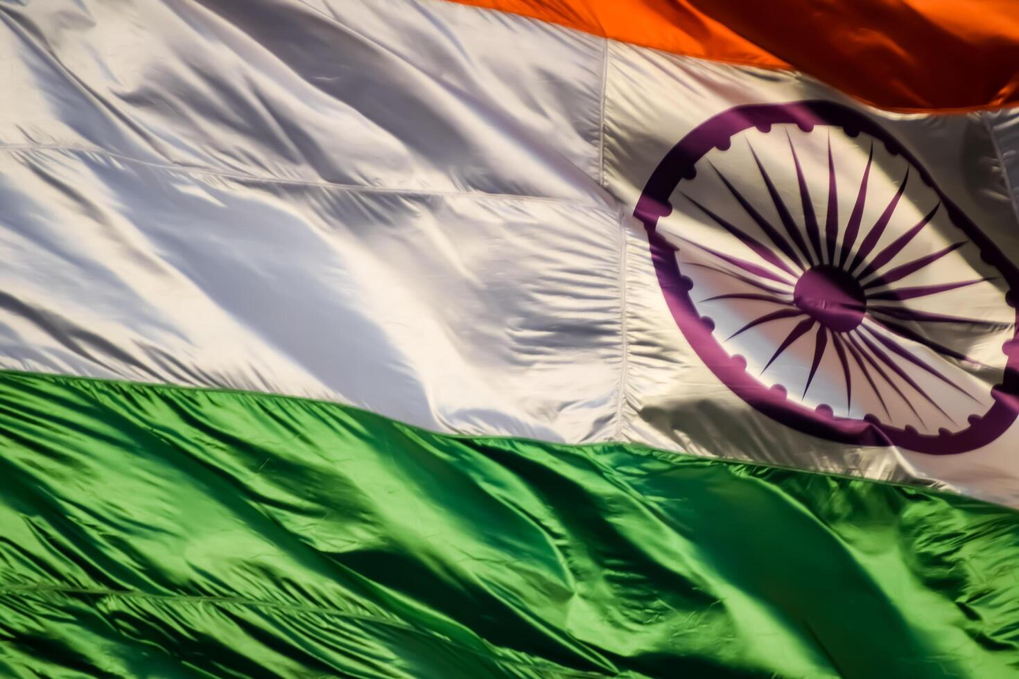 India flag flying high at Connaught Place with pride in blue sky, India flag fluttering, Indian Flag on Independence Day and Republic Day of India, tilt up shot, Waving Indian flag, Har Ghar Tiranga photo