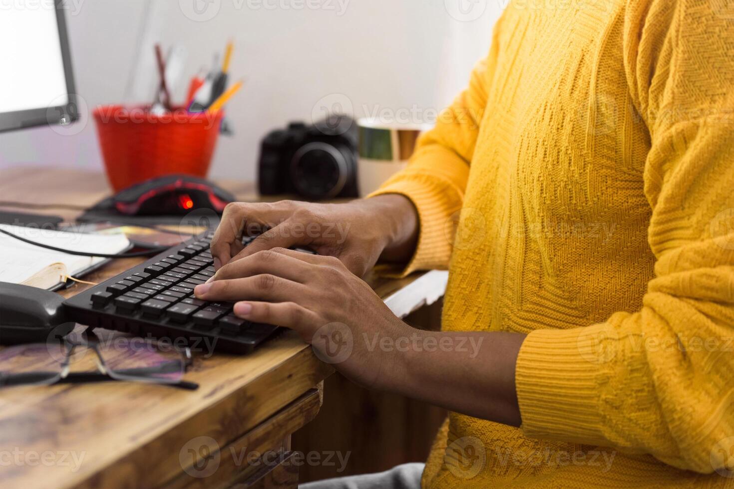 unrecognizable person typing on a computer keyboard with copy space. photo